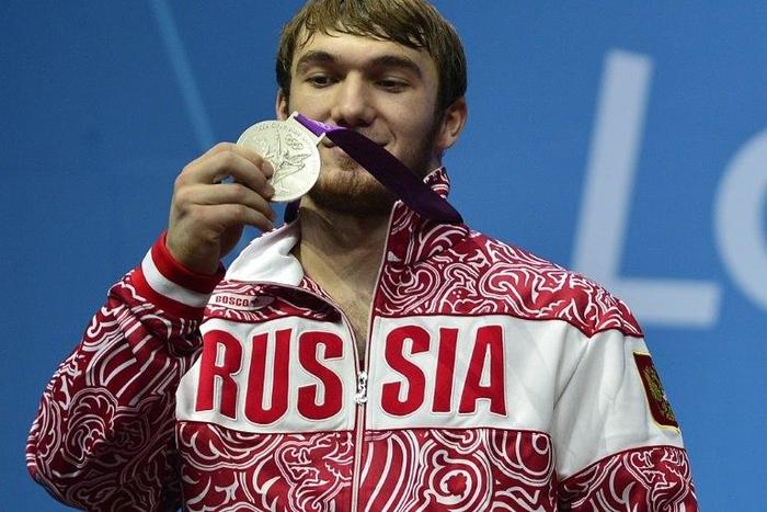 Russia's Apti Aukhadov, pictured on the podium of the men's 85kg weightlifting event at the 2012 Olympic Games, was stripped of his silver medal by the IOC after a sample re-test came back positive for drugs