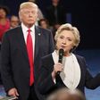 Republican U.S. presidential nominee Donald Trump listnes as Democratic nominee Hillary Clinton answers a question