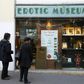 Two people stand in front of the the Erotic Museum of Paris on November 2, 2016 prior to the auction sale of the collection on November 6 and the closure of the museum