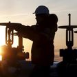 Worker checks valve of oil pipe at Lukoil company owned Imilorskoye oil field outside West Siberian city of Kogalym