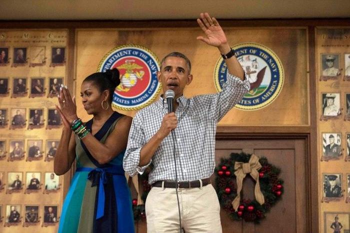 US President Barack Obama addresses troops with First Lady Michelle Obama at Marine Corps Base Hawaii in Kailua on December 25, 2016