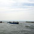Uganda Police divers and local fishermen search for victims of a boat disaster on Lake Albert near Kitebere on March 23, 2013