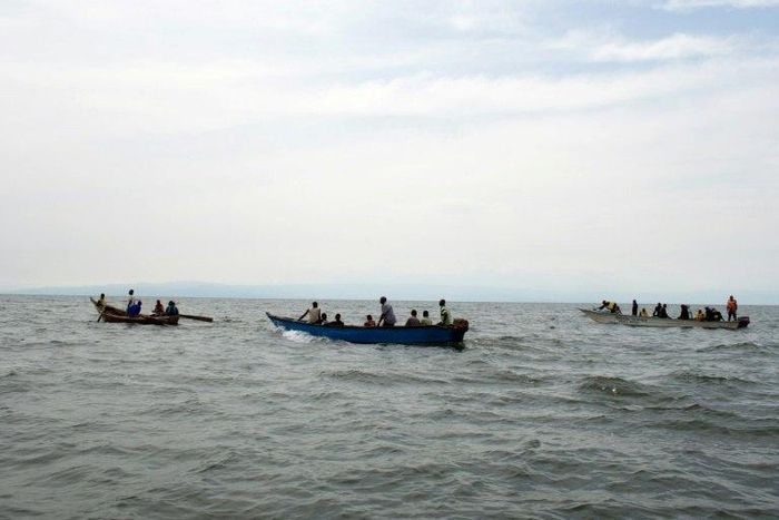 Uganda Police divers and local fishermen search for victims of a boat disaster on Lake Albert near Kitebere on March 23, 2013