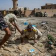 Fighters loyal to Libya's Government of National Accord help a wounded comrade after he was shot by an Islamic State group sniper on the western frontline in Sirte on October 2, 2016