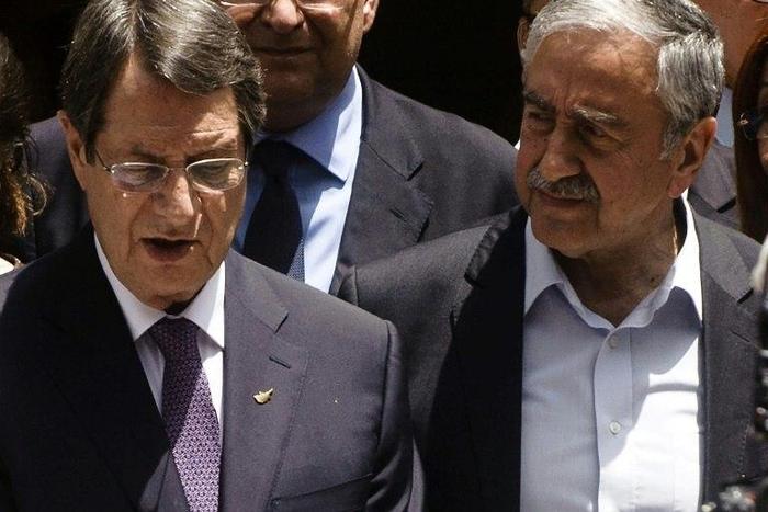 Greek Cypriot President Nicos Anastasiades (L) and Turkish Cypriot leader Mustafa Akinci, seen together during a social function in Nicosia's UN-patrolled buffer zone, in June 2016