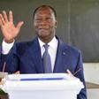 Ivory Coast's President Alassane Ouattara gestures after casting his vote in the ballot box, at a polling station in Abidjan, on October 30, 2016, during a vote for a referendum on a new constitution