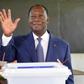 Ivory Coast's President Alassane Ouattara gestures after casting his vote in the ballot box, at a polling station in Abidjan, on October 30, 2016, during a vote for a referendum on a new constitution