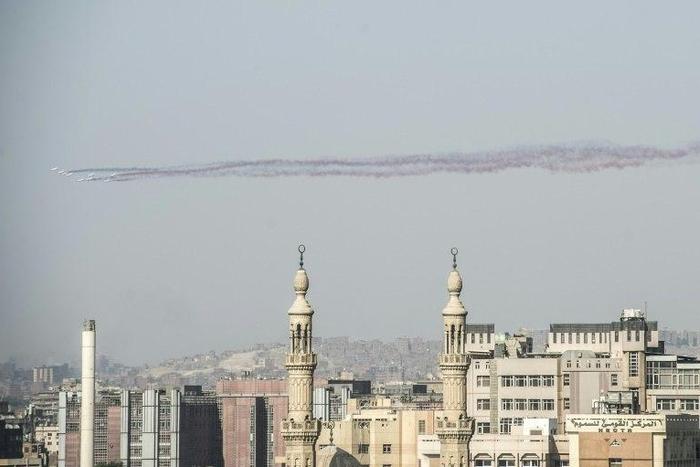 Three photojournalists have been detained after conducting street interviews with members of the public in central Cairo
