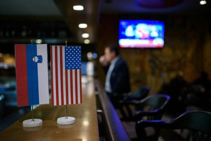Slovenian and US national flags in Sevnica, hometown of Melania Trump, on television, November 9, 2026