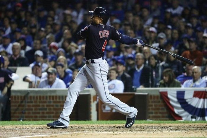 Coco Crisp of the Cleveland Indians hits a single in the seventh inning against the Chicago Cubs, in Game Three of the 2016 World Series, at Wrigley Field in Chicago, Illinois, on October 28
