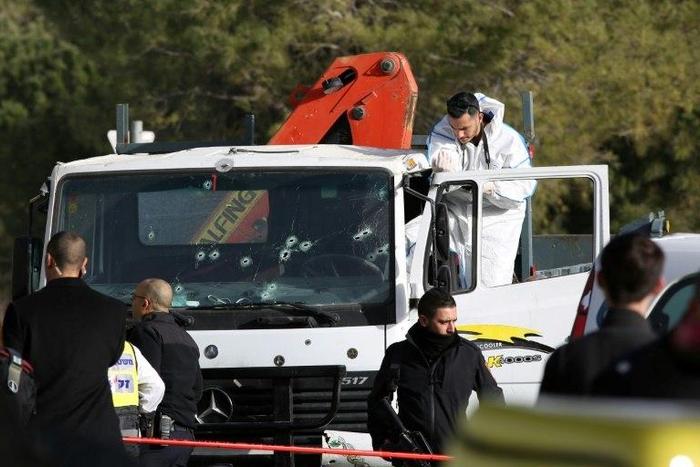 An Israeli forensics expert gathers evidence at the site of the attack in Jerusalem, on January 8, 2017
