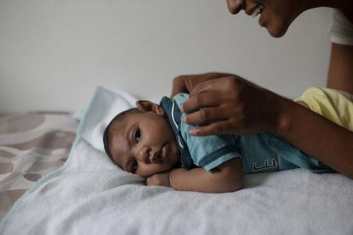 Mariam Araujo, 25, plays with Lucas, her 4-months old second child and born with microcephaly as they wait for a physiotherapy session in Pedro I hospital in Campina Grande, Brazil, February 17, 2016.