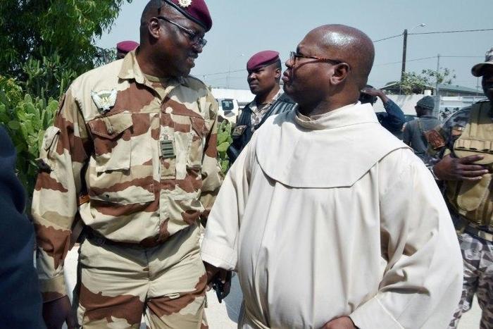 Lieutenant-Colonel Issiaka Ouattara (left) speaks with Archbishop Paul-Simeon Ahouanan Djro as unrest sweeps through Ivory Coast's second city of Bouake, on January 7, 2017