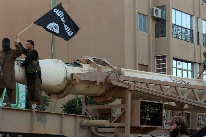 Image made available by Jihadist media outlet Welayat Raqa on June 30, 2014 claims to show members of the IS (militant group parading with a missile in the northern rebel-held Syrian city of Raqa