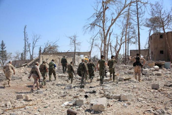 Forces loyal to Syria's President Bashar al-Assad walk at a military complex, after they recaptured areas in southwestern Aleppo that rebels had seized last month, Syria, in this handout picture provided by SANA on September 5, 2016.