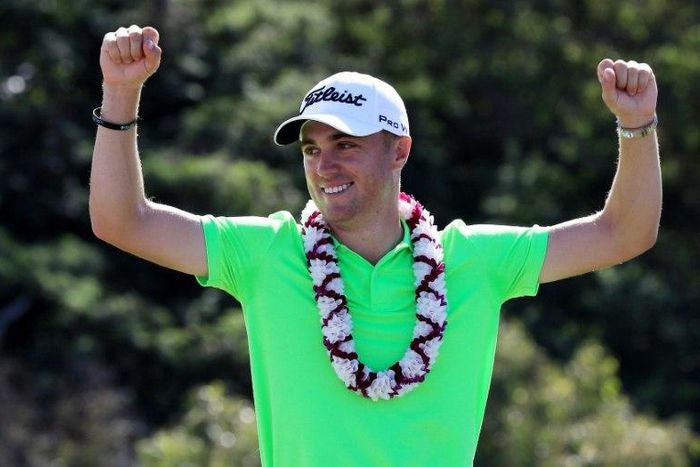 Justin Thomas of the United States celebrates on the 18th green after winning at Kapalua Golf Club, Hawaii
