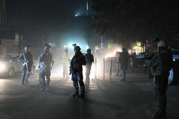 Afghan Crisis Response Unit personnel stand guard at the site of a bomb attack on the Spanish embassy compound in Kabul on December 11, 2015