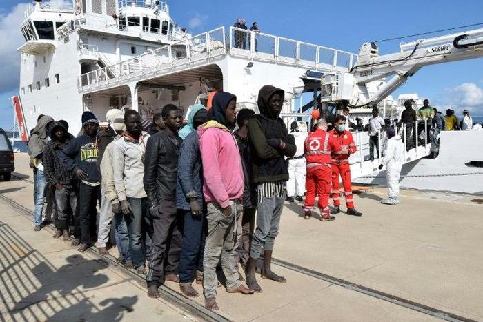 Migrants and refugees arrive in the port of Messina in Sicily following a rescue operation at sea by the Italian coastguard ship 'Diciotti', in March 2016