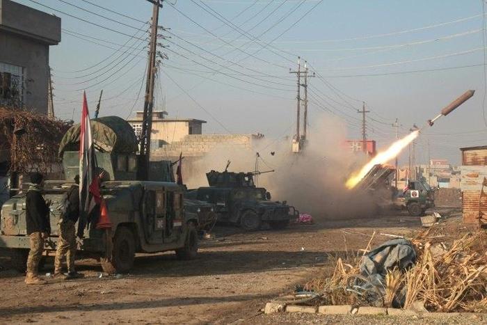 Iraqi forces launch a rocket in Mosul's eastern Al-Intisar neighbourhood on December 30, 2016, during an ongoing military operation against Islamic State (IS) group jihadists