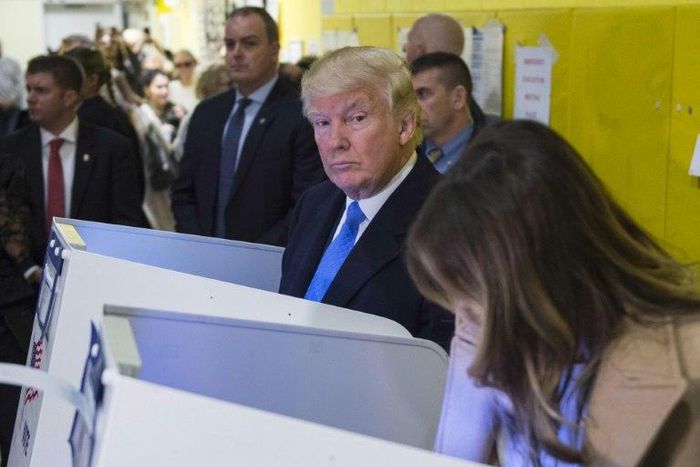 Republican presidential nominee Donald Trump and his wife Melania fill out their ballots at a polling station in a school during the 2016 presidential elections on November 8, 2016 in New York