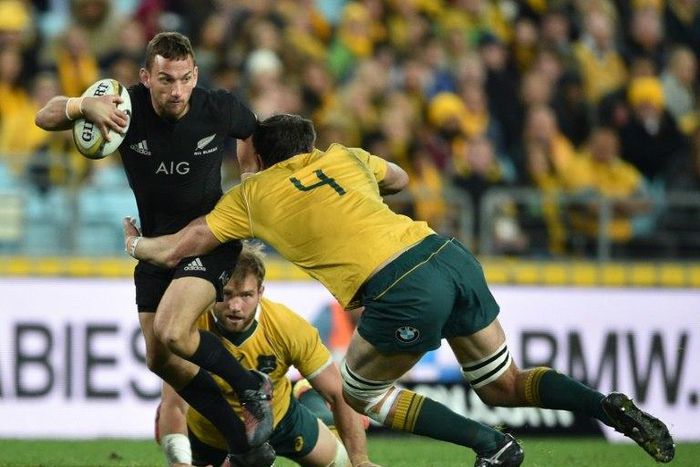 Aaron Cruden of New Zealand (L) is tackled by Kane Douglas of Australia during their Bledisloe Cup match in Sydney, on August 20, 2016