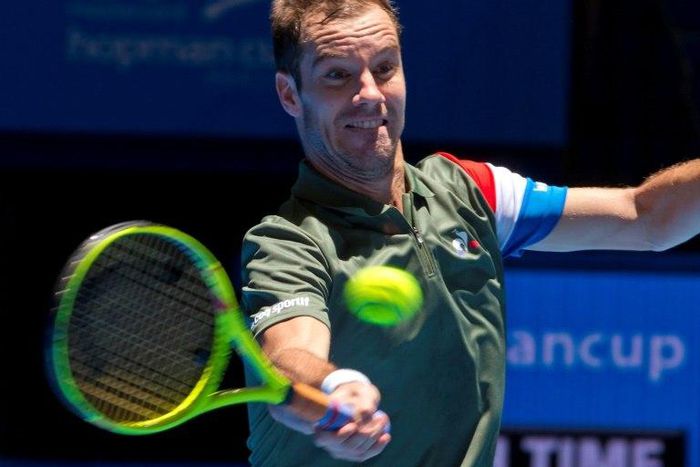 Richard Gasquet of France hits a return against Alexander Zverev of Germany during their third session men's singles match on day two of the Hopman Cup, in Perth, on January 2, 2017