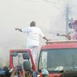 Governor Ayo Fayose joins firemen to put out a fire. 