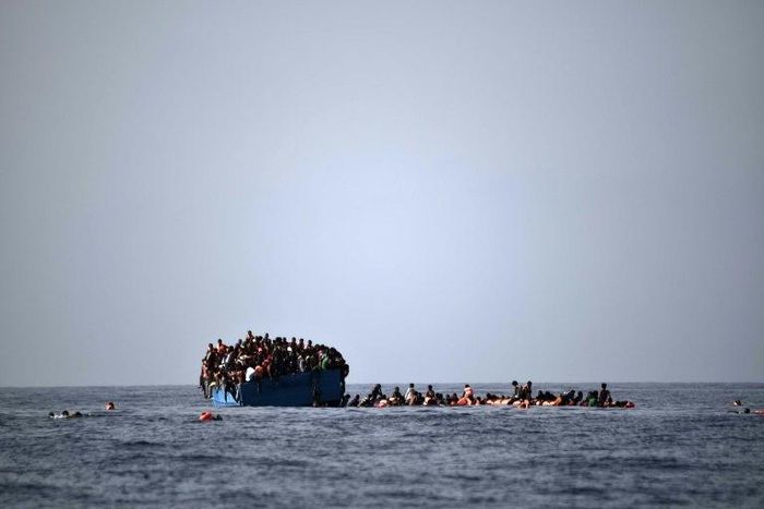 Migrants wait to be rescued by members of Proactiva Open Arms NGO in the Mediterranean Sea, some 12 nautical miles north of Libya, on October 4, 2016