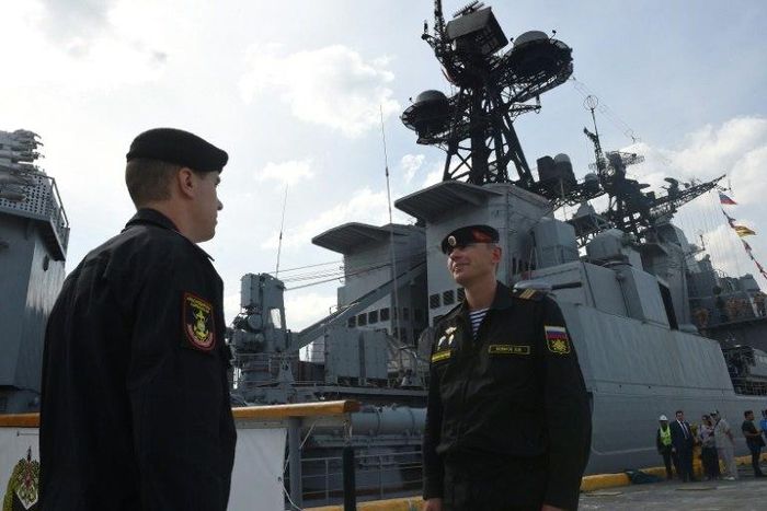 Russian Navy sailors stand guard at the gangway leading to the anti-submarine ship Admiral Tributs shortly after arriving at port in Manila on January 3, 2017