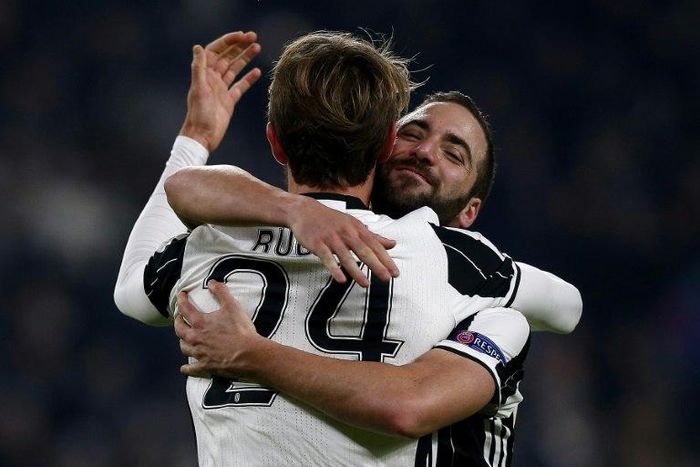 Juventus' defender Daniele Rugani celebrates after scoring with teammate Gonzalo during their UEFA Champions League football match against Dinamo Zagreb on December 7, 2016