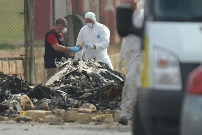 Forensics officials work at the site of a plane crash at Malta international airport on October 24, 2016