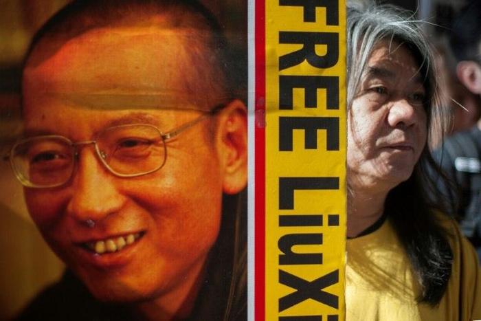 Hong Kong activist and legislator Leung Kwok-hung, popularly known as "Long Hair", holds a placard calling for the release of Chinese human rights activist Liu Xiaobo on May 18, 2016
