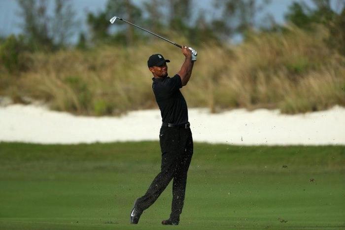 Tiger Woods of the United States hits his second shot on the 16th hole during round one of the Hero World Challenge at Albany, The Bahamas on December 1, 2016