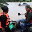 Rescue workers ride a boat as they patrol an area flooded in Sichon District, Nakhon Si Thammarat province, Thailand December 3, 2016.