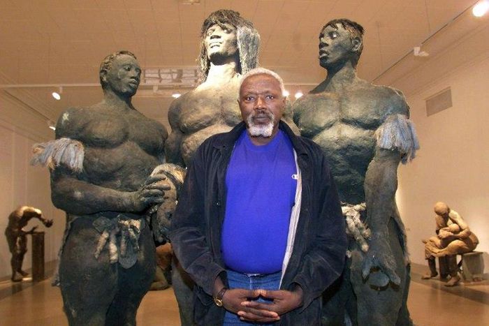 Senegalese sculptor Ousmane Sow posing in front of one of his artworks in Lyon in 1999