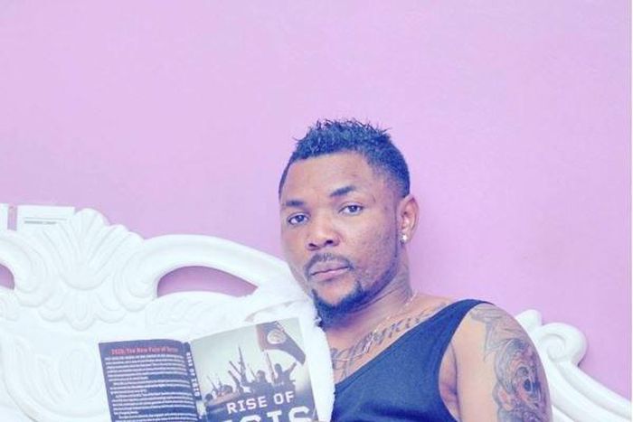 Singer Oritsefemi reading 'Rise of ISIS'