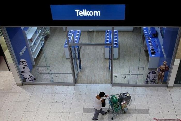 A shopper walks past a Telkom shop at a mall in Johannesburg February 26, 2016.