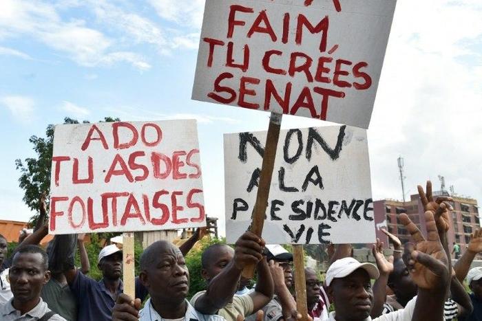 Ivory Coat's opposition supporters hold placards reading 'No to a presidency for life' during protests against a referendum on the adoption of a new constitution, in Abidjan, on October 20, 2016