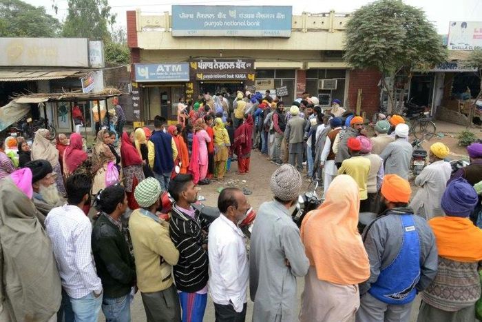 Villagers queue outside a bank in Khasa village, some 20kms from Amritsar, northwest India, as they wait to deposit and exchange 500 and 1000 rupees on November 12, 2016