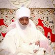 The Emir of Kano is seen holding his grand-daughter.