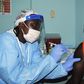 A health worker injects a woman with an Ebola vaccine during a trial in Monrovia, February 2, 2015. REUTERS/James Giahyue (LIBERIA - Tags: DISASTER HEALTH)