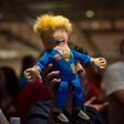 A supporter of Republican presidential candidate Donald Trump holds up a Trump doll during an election night party at a hotel in downtown Phoenix, Arizona