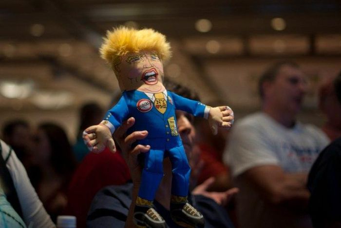 A supporter of Republican presidential candidate Donald Trump holds up a Trump doll during an election night party at a hotel in downtown Phoenix, Arizona