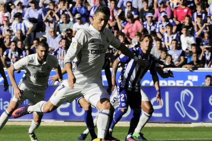 Real Madrid's forward Cristiano Ronaldo kicks the ball to score a goal during the Spanish league football match between Deportivo Alaves and Real Madrid CF at the Mendizorroza stadium in Vitoria on October 29, 2016