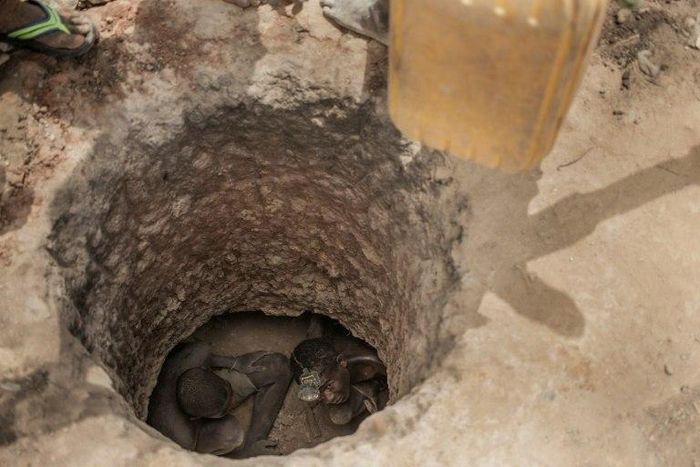 TTwo Malagasy men mine for gems and Sapphire at an informal Sapphire mine on on the outskirts of Sakaraha, Madagascar