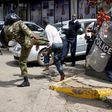  Kenyan policemen beat a protester during clashes in Nairobi, Kenya May 16, 2016.