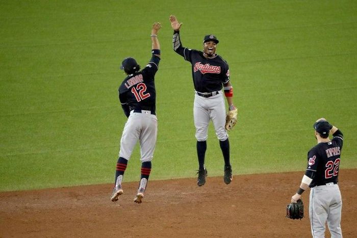 Francisco Lindor (L) and Rajai Davis of the Cleveland Indians celebrate after defeating the Toronto Blue Jays at Rogers Centre on October 17, 2016 in Canada