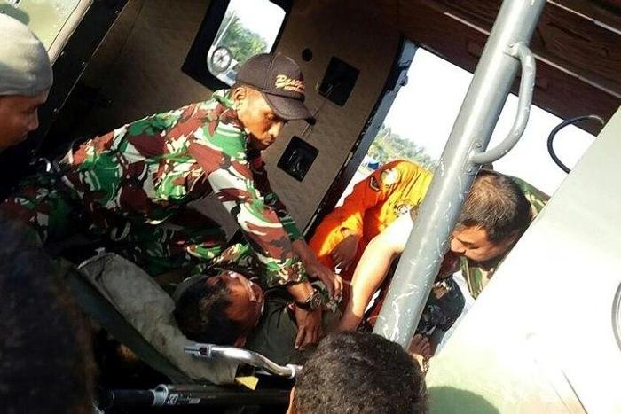A photo released on November 28, 2016 shows Indonesian pilot Abdi Damain being rescued three days after his helicopter crashed in Kalimantan