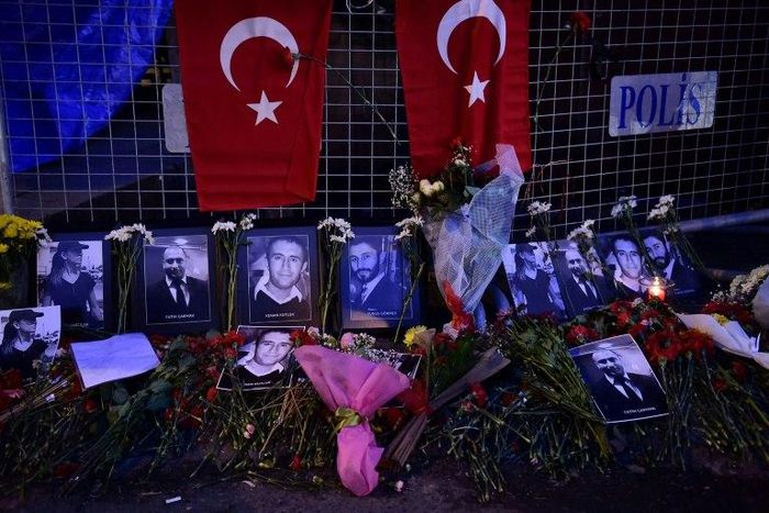 Flowers and portraits of victims of the Reina nightclub attack are laid near the venue in Istanbul as reports emerge claiming the gunman had fought for the Islamic State group in Syria