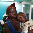 A mother holds her child suffering from yellow fever at a hospital in Luanda, Angola, March 15, 2016.